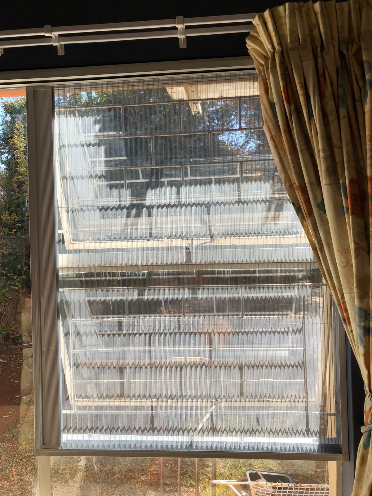 Custom flyscreen fitted to a steel-frame opening 1