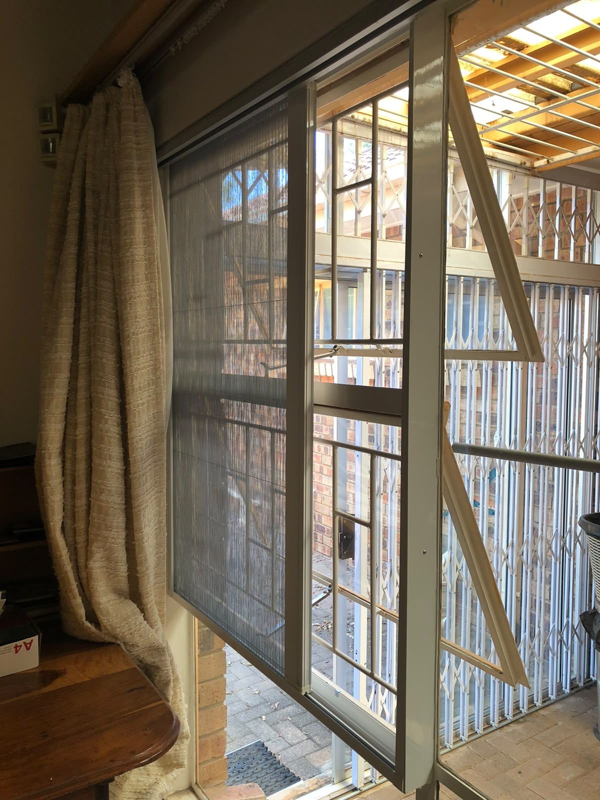 Custom flyscreen fitted to a steel-frame opening 2