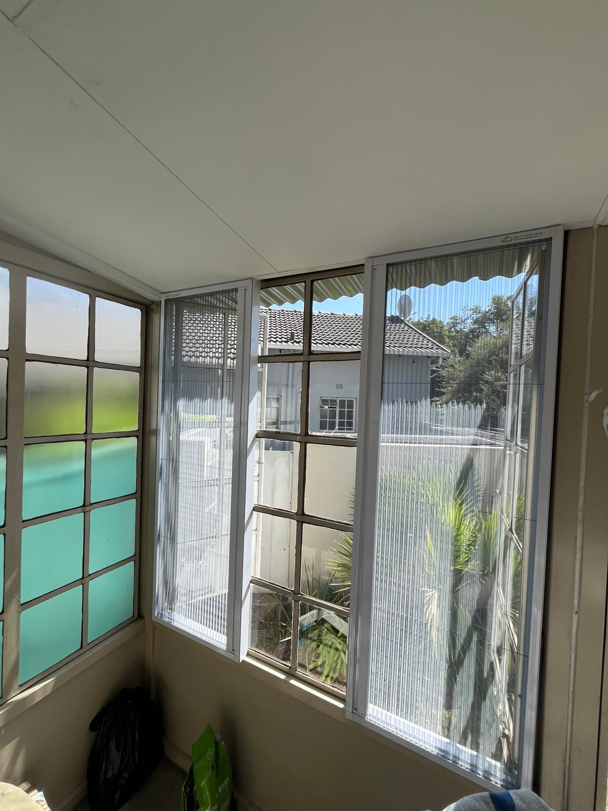 Custom flyscreen fitted to a steel-frame opening 5
